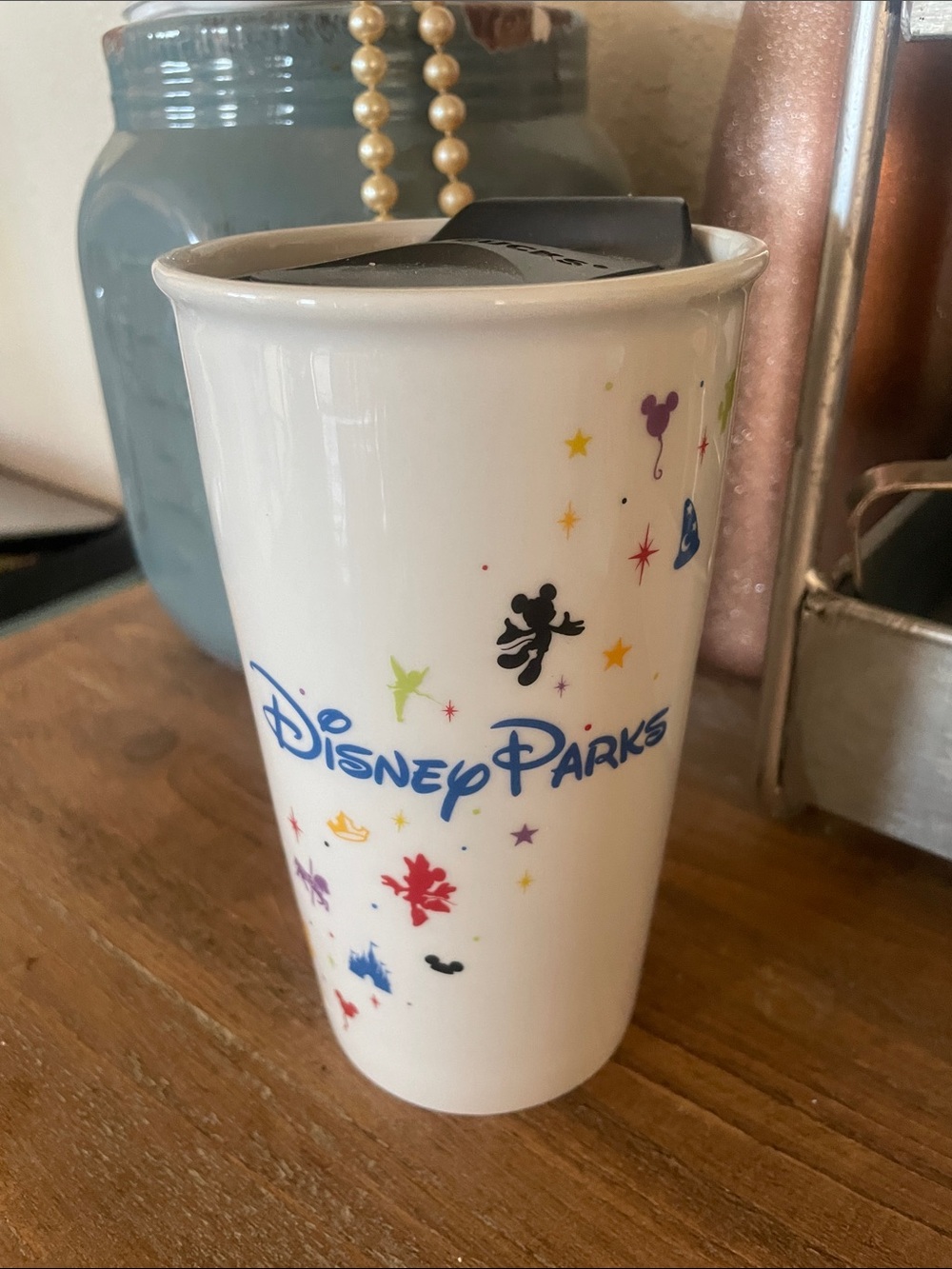 Starbucks Disney Parks 12 oz Ceramic Tumbler from 2015 featuring colorful icons